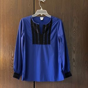 Chico’s long sleeved deep blue top with black beaded neck and cuff. Size Chico 0